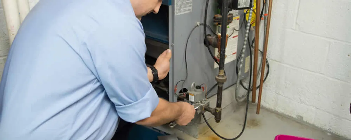 Furnace repair technician inspecting and servicing a home heating system in Albany, NY