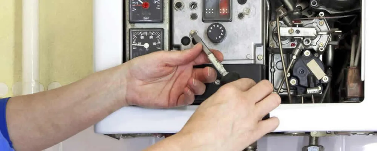 Heating repair technician adjusting boiler controls and components in Albany, NY