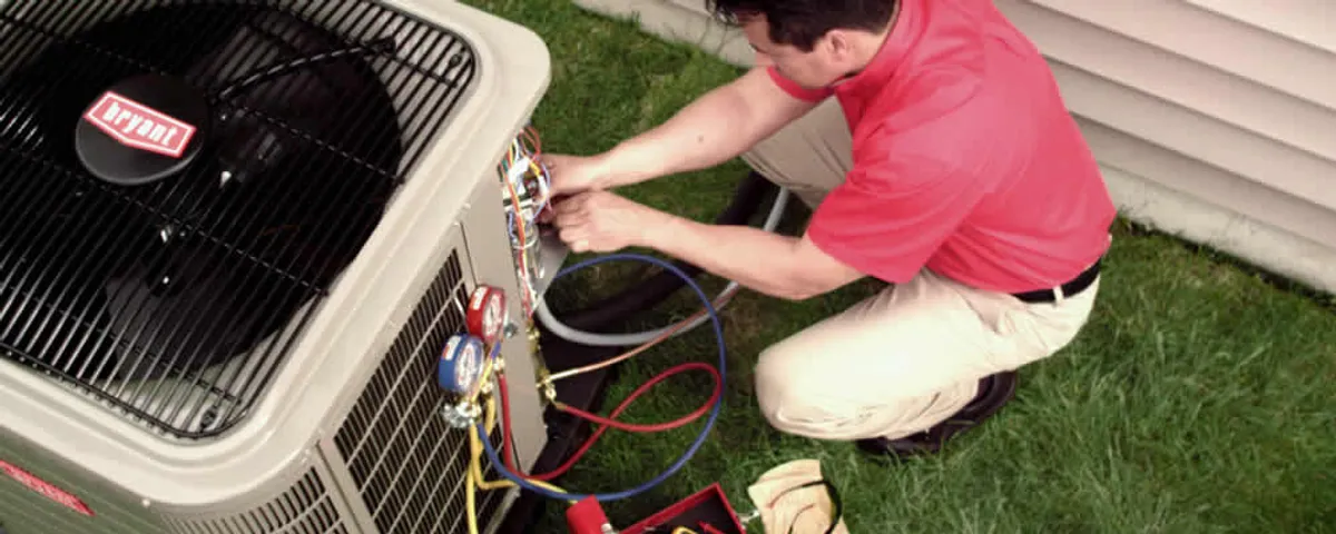 HVAC technician servicing an outdoor air conditioner unit in Albany, NY